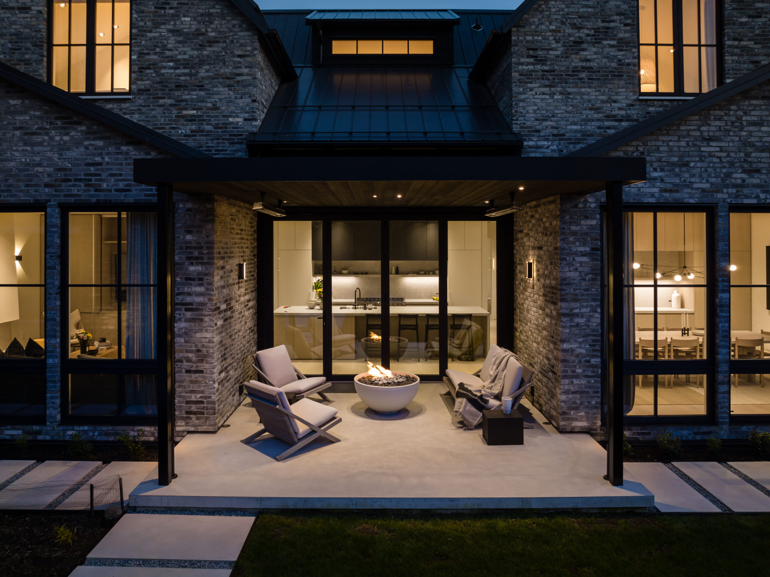 Scandia custom home outdoor living area with firepit and seating