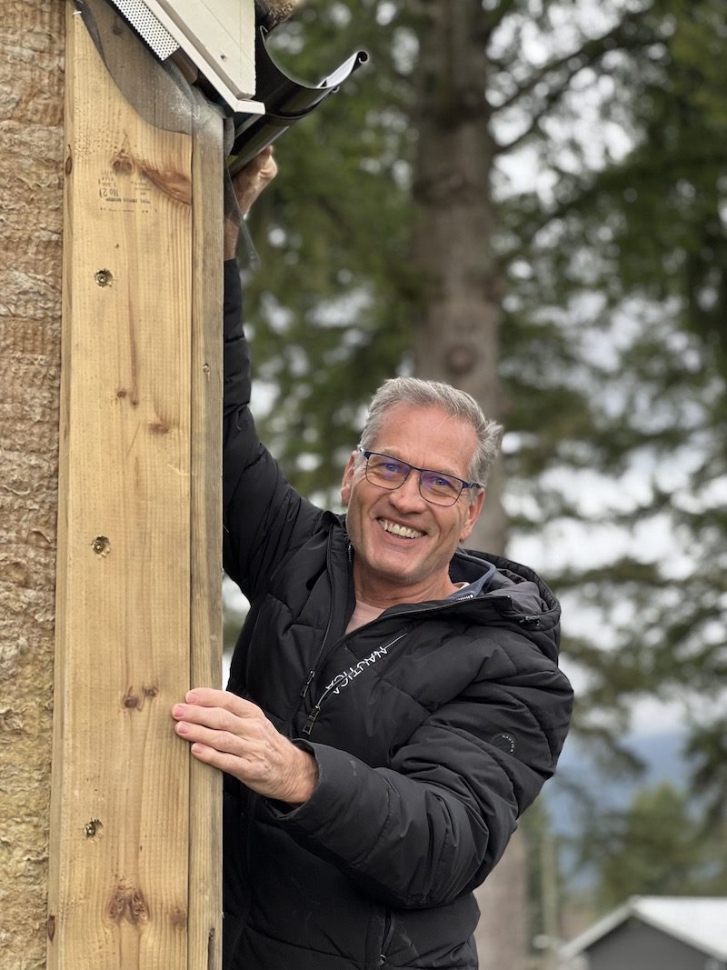 Homeowner in North Vancouver smiles after learning how to choose a custom home builder