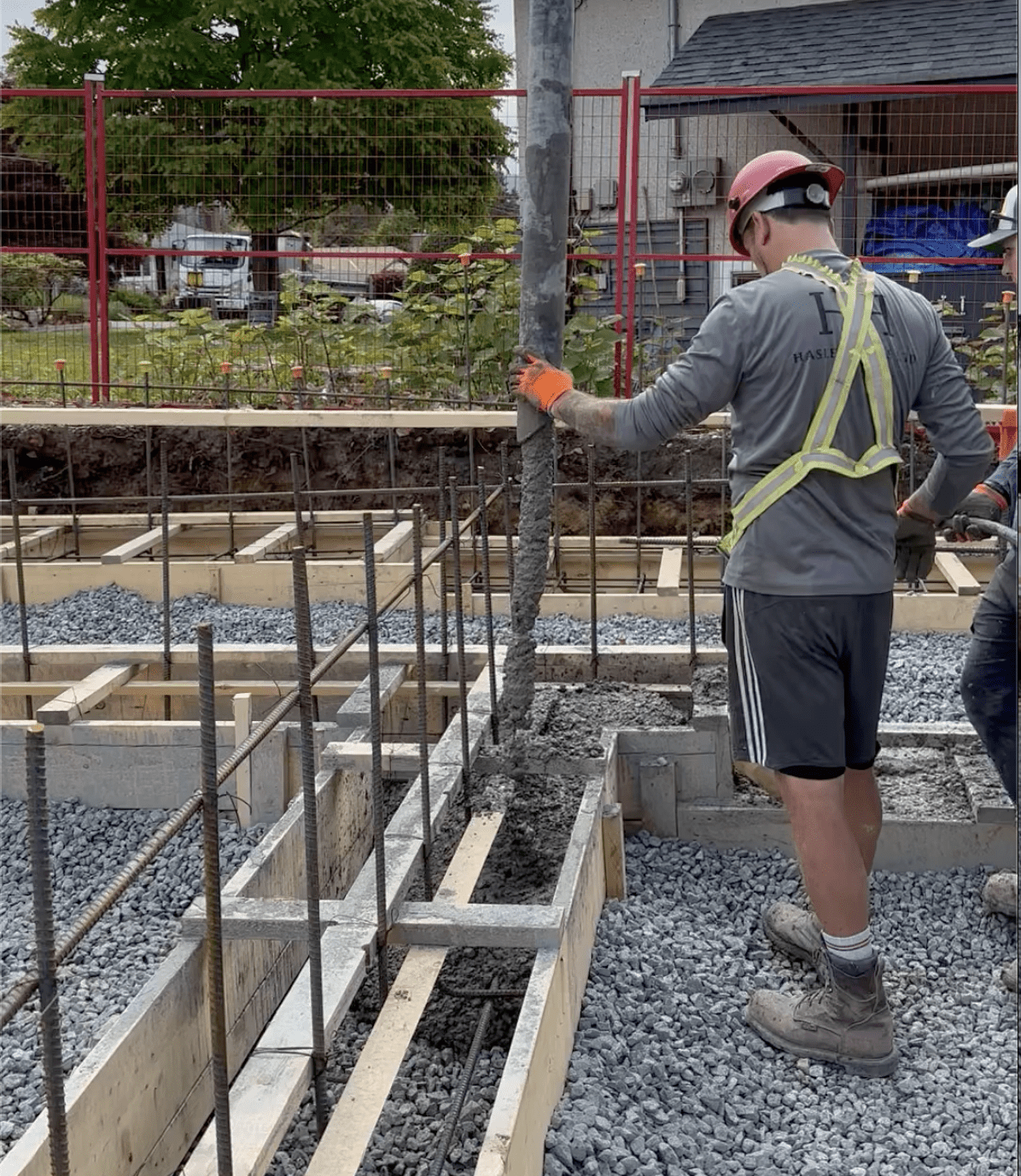 Man pouring concrete at Hasler Homes custom home job site