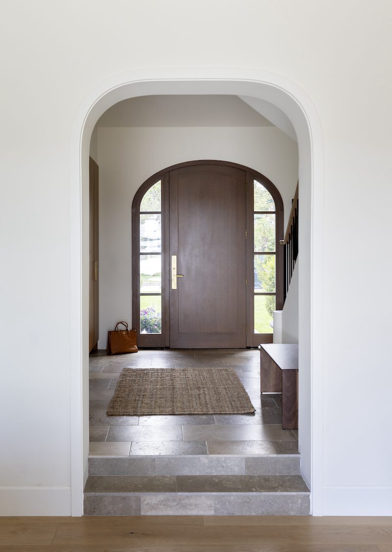 An interior arched entrance to a foyer in a custom home in North Vancouver