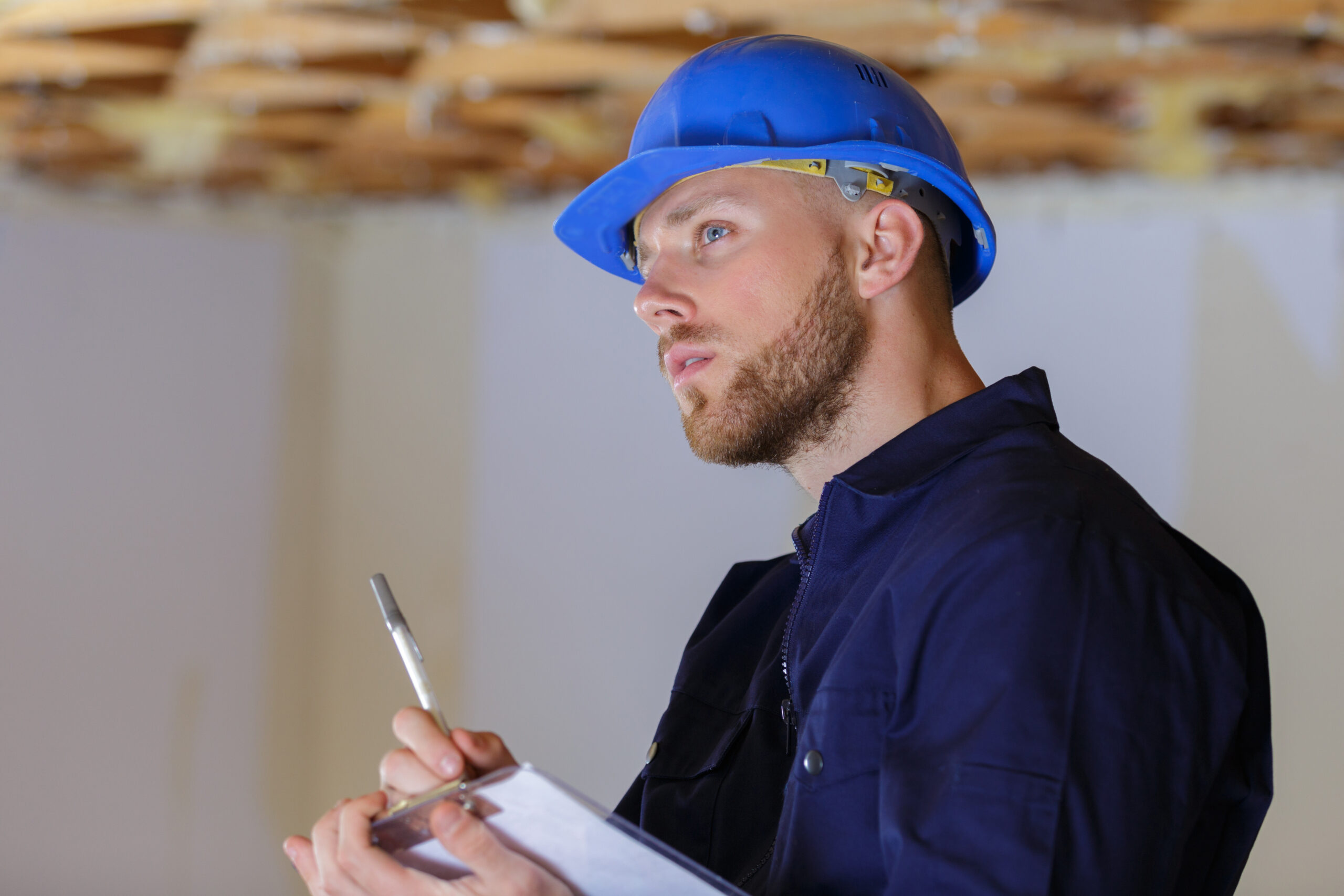 Home inspector examining building enclosure of North Vancouver home