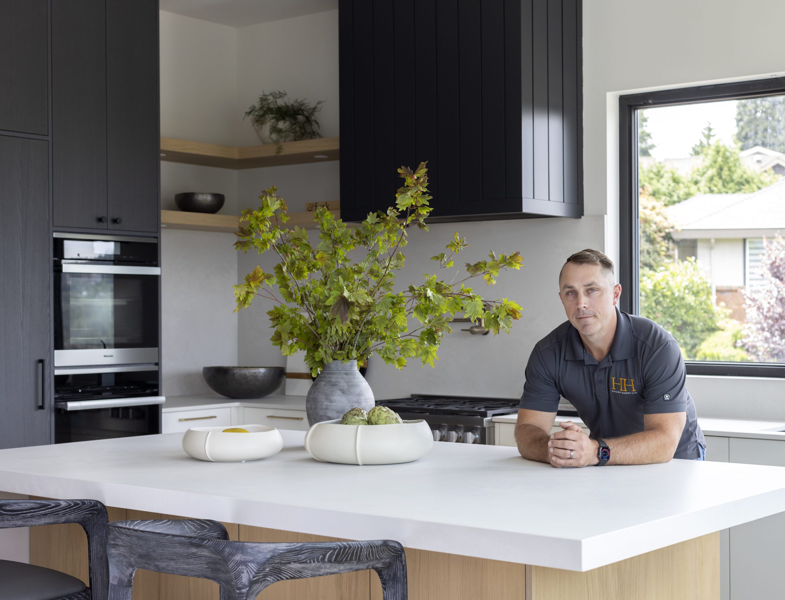 Greg Hasler, owner of Hasler Homes, in a custom kitchen, discussing tips for successful fall home renovations in Vancouver