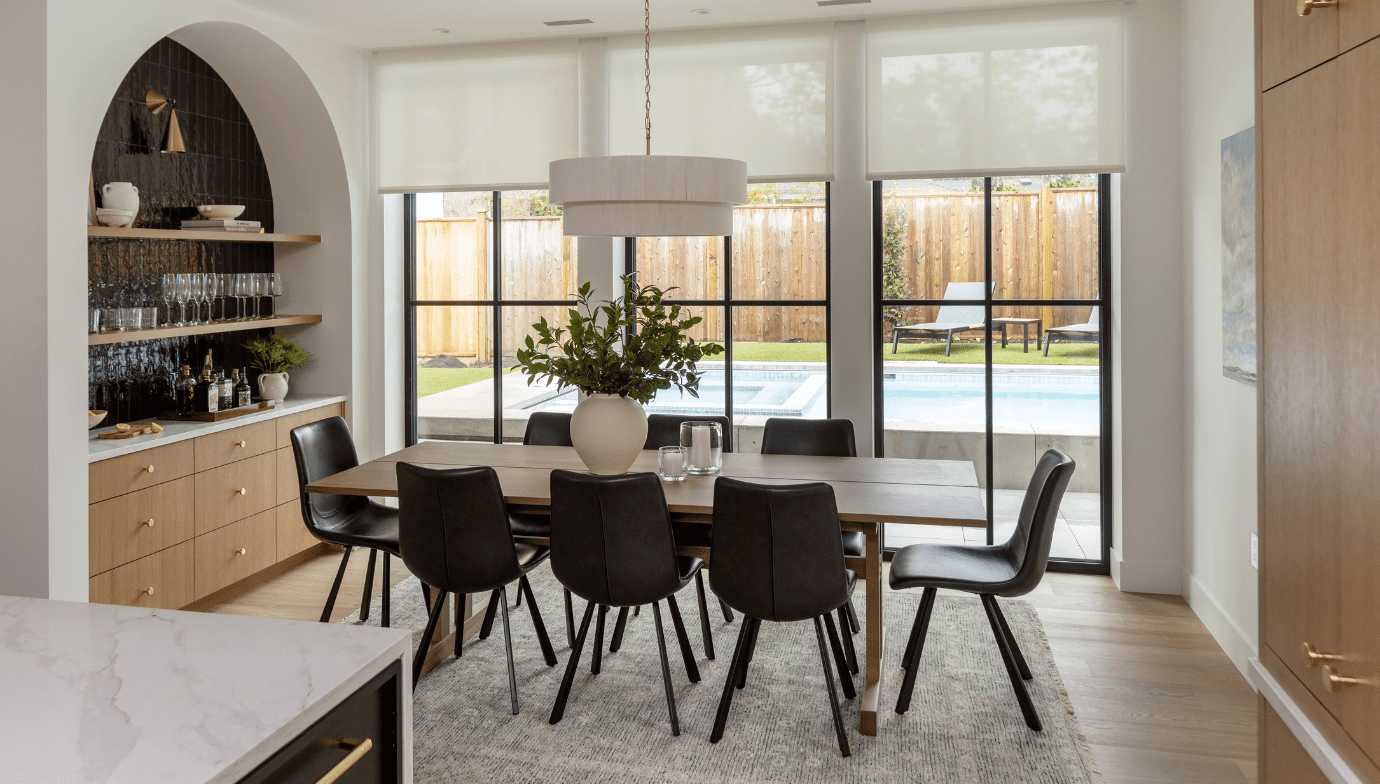 Haven dining room and kitchen looking out onto the backyard pool