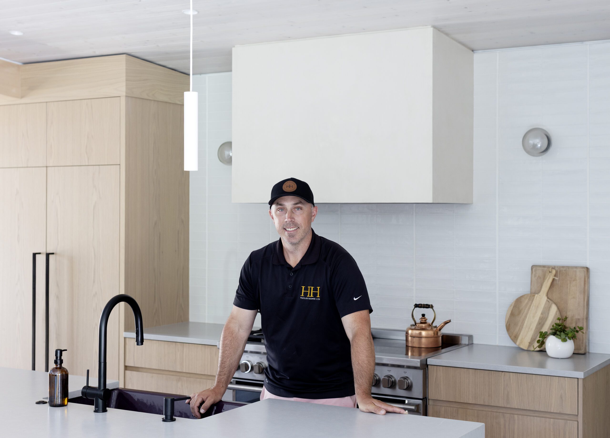 Home renovation questions featured image showing Greg Hasler, of Hasler Homes, in the completed kitchen at Valleyhouse custom home