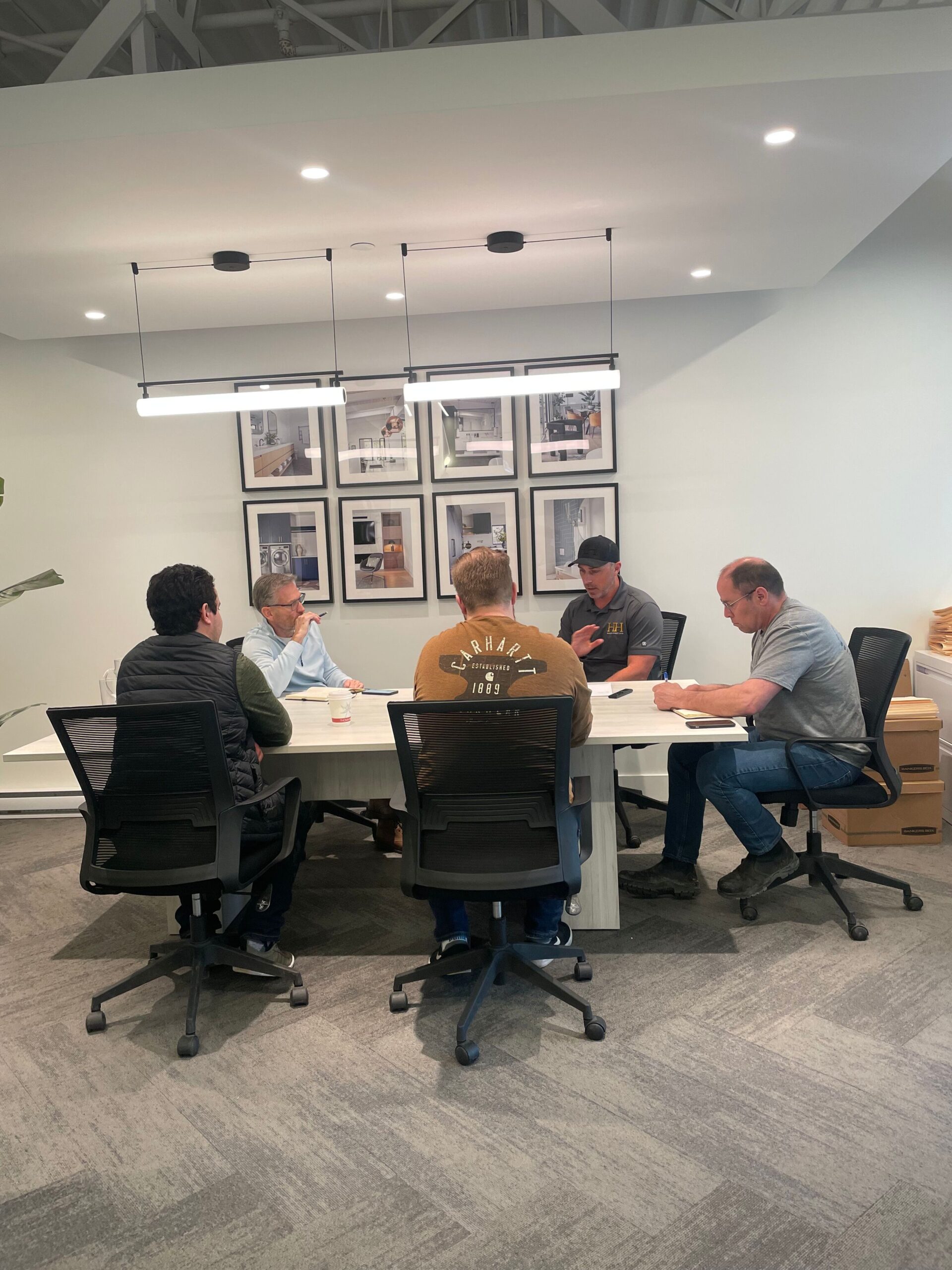 Greg Hasler and the Hasler Homes team meeting with designers and trades to plan a custom home project - part of what custom home builders do throughout the building process