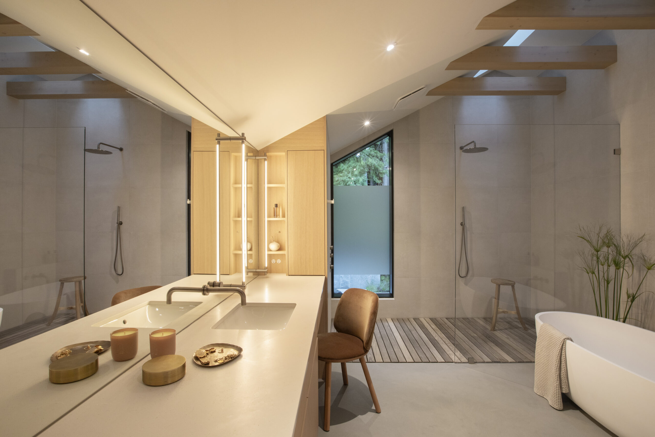 Primary ensuite with skylight, soaker tub and wood beams at Japandia