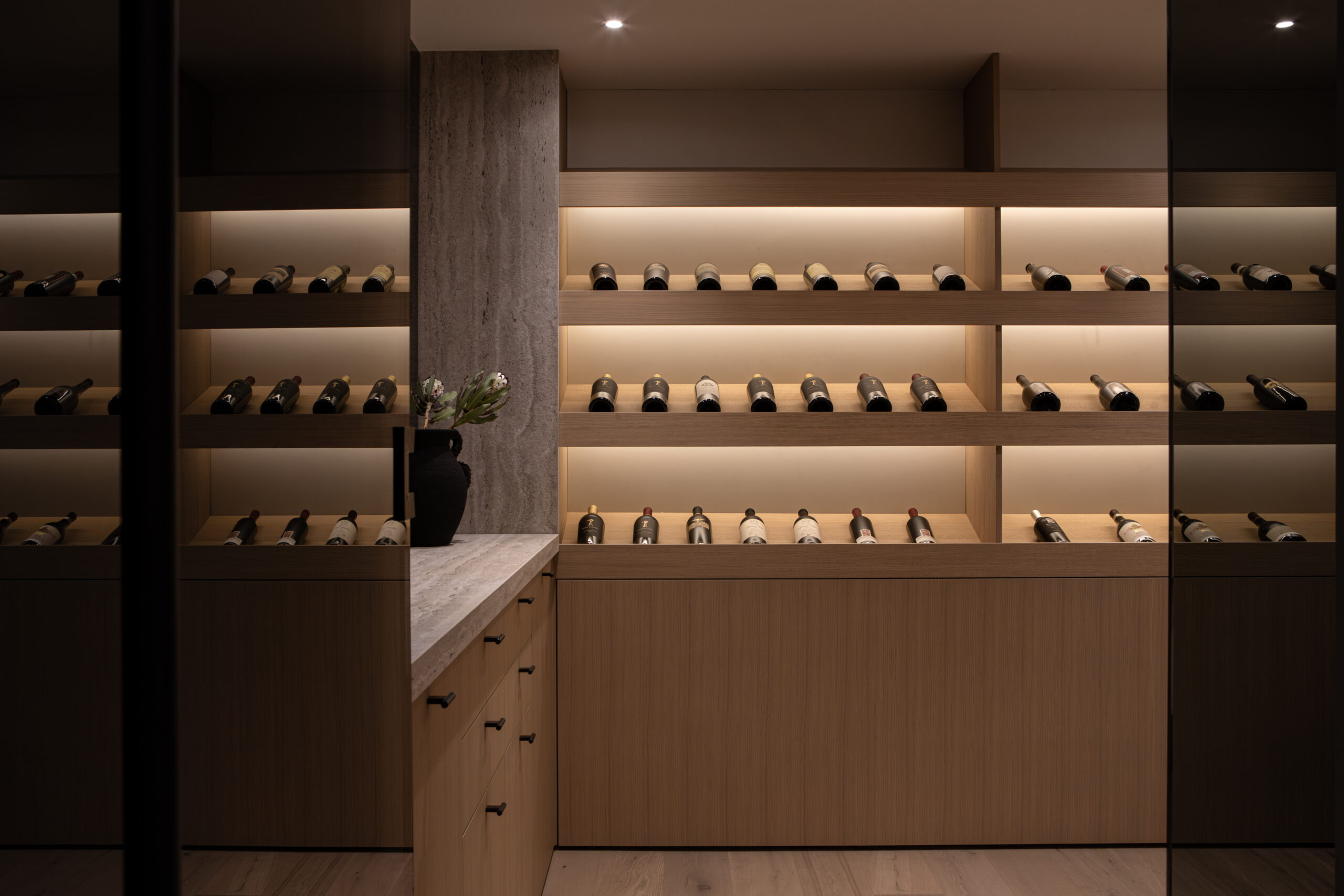 Custom wine room with built-in wine storage at Japandia residence